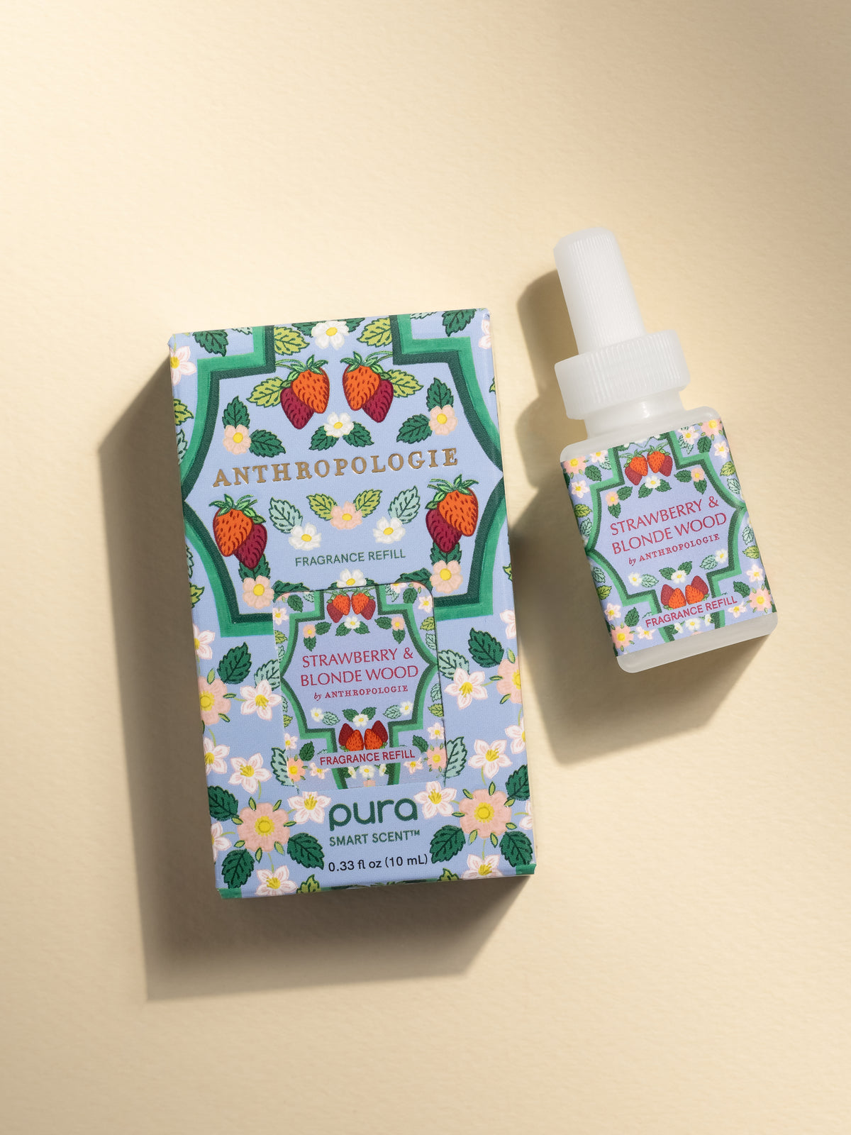 Anthropologie Strawberry & Blonde Wood fragrance vial and packaging on a beige background
