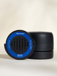 Capri Blue Volcano car fragrance next to a Pura car diffuser