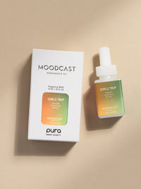 Moodcast Girls Trip fragrance vial and packaging on a beige background
