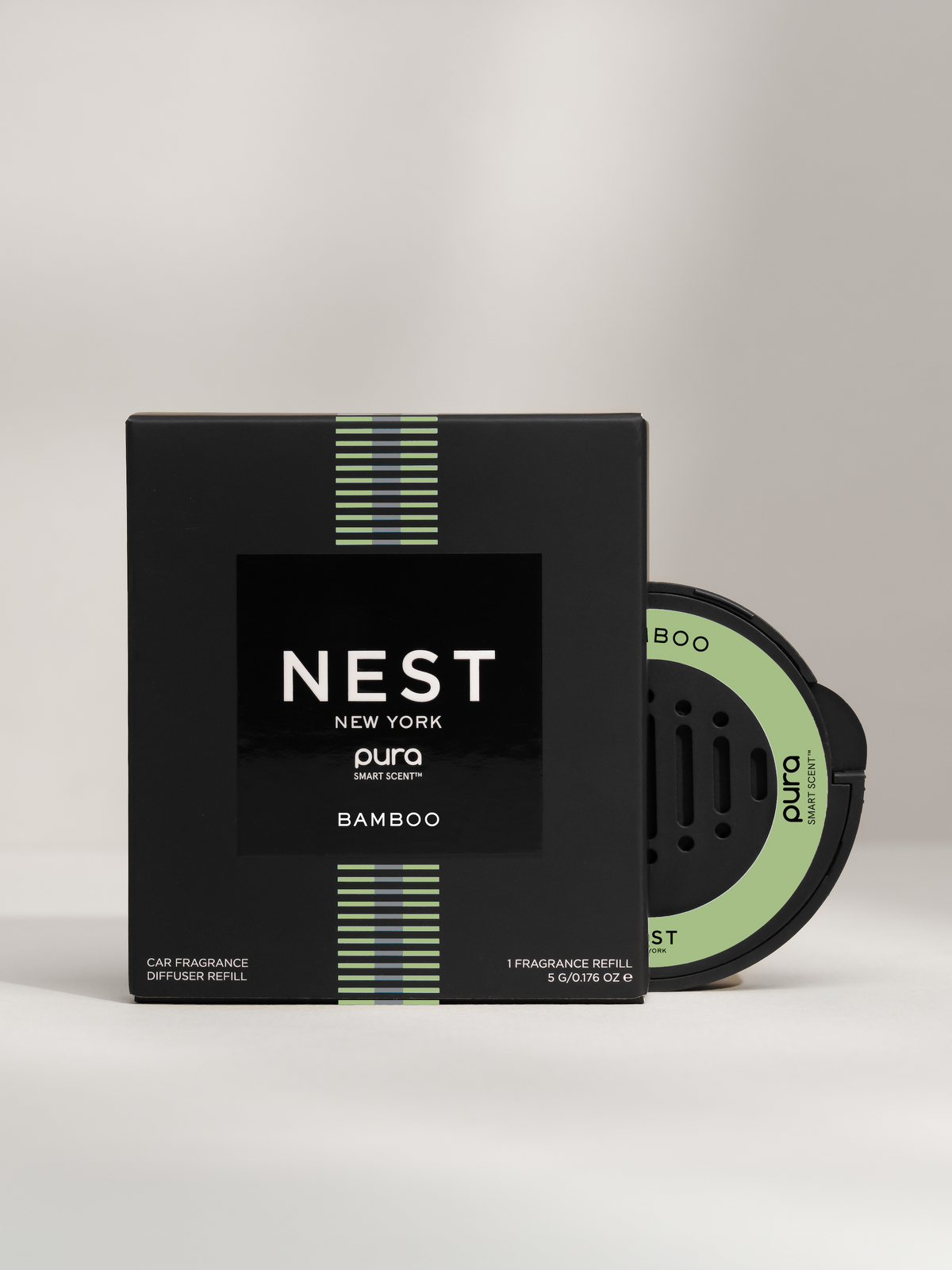 A Nest New York Bamboo car fragrance and packaging on a light gray background