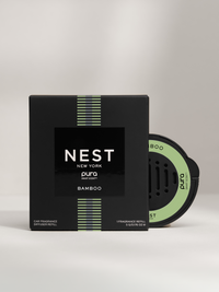A Nest New York Bamboo car fragrance and packaging on a light gray background