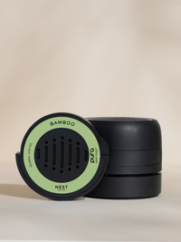 A Nest New York Bamboo car fragrance and packaging on a light gray background