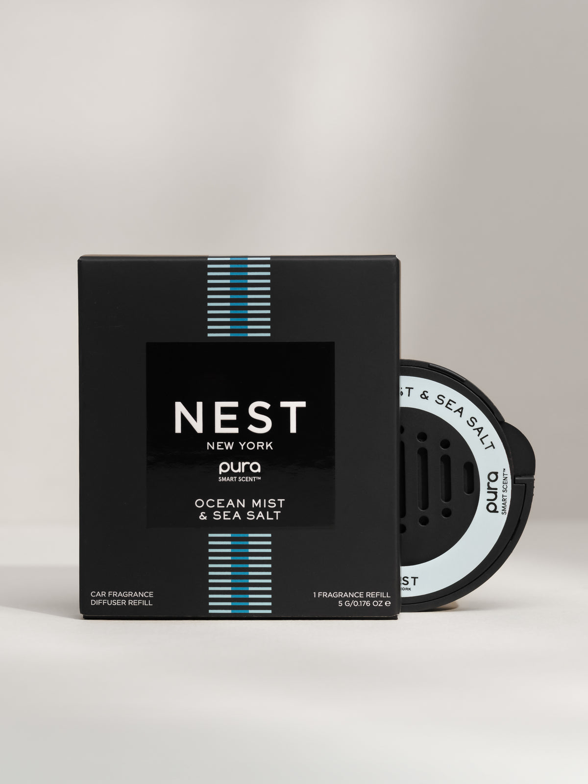 NEST New York Ocean Mist and Sea Salt car fragrance and packaging on a gray background
