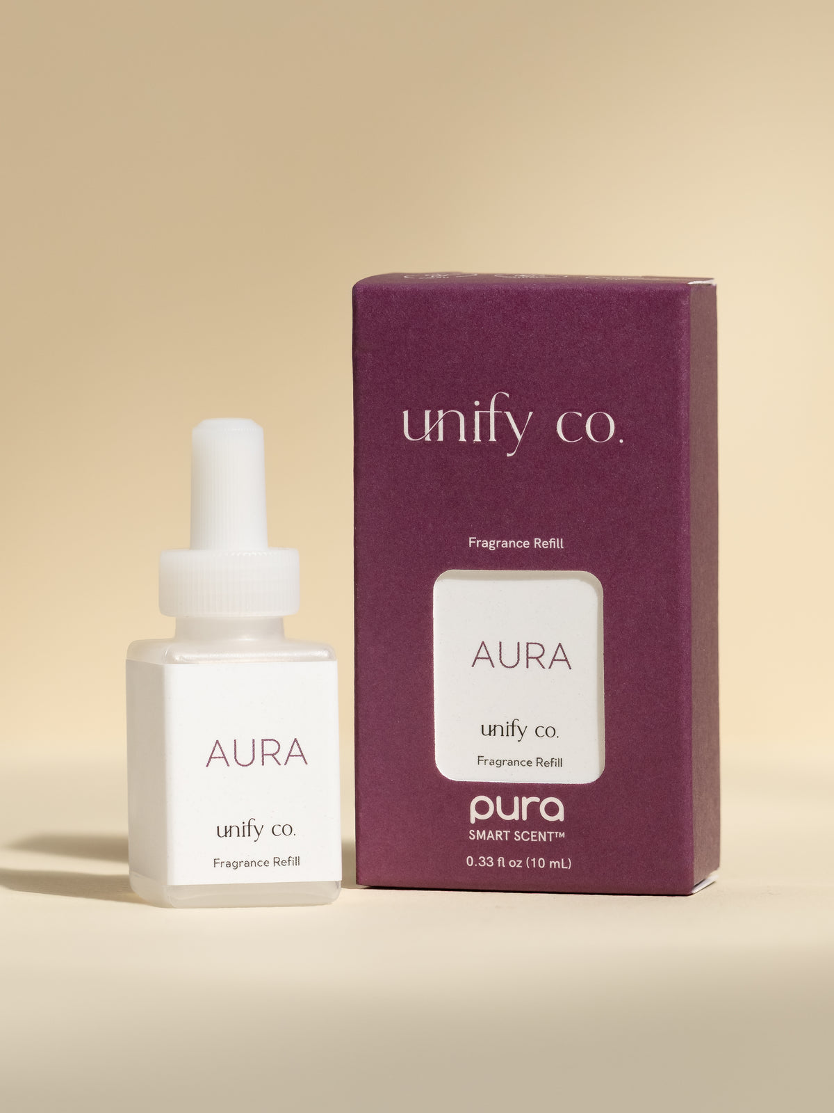 Unify Co Aura fragrance vial and packaging on a beige background