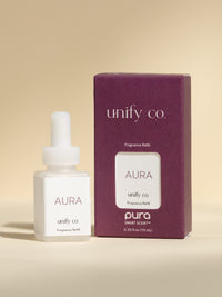 Unify Co Aura fragrance vial and packaging on a beige background
