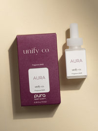 Unify Co Aura fragrance vial and packaging on a beige background