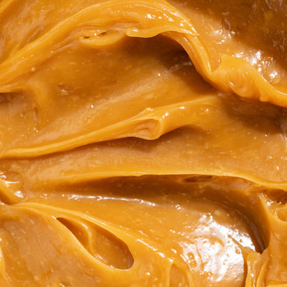 Close-up of smooth, amber-colored caramel